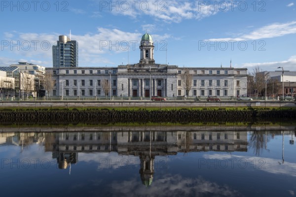 Cork city hall building reflected on river lee. Ireland Europe