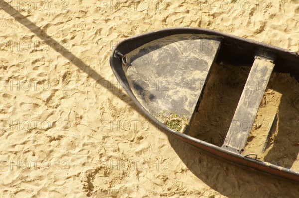 Aerial view and top view of a sandy beach with an old tin rowing boat