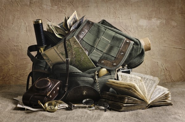 Still life with an old backpack and travel accessories