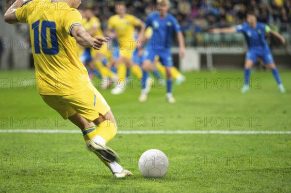 Soccer ball and legs of player during football match