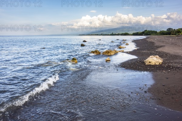 An image of a dark sand beach in northern Bali Indonesia