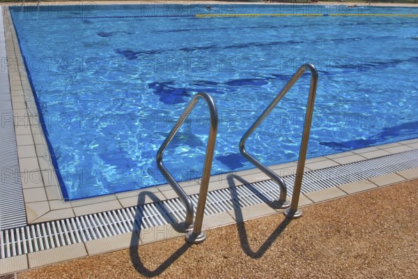 Pool with pure transparent water and hand-rail of descent