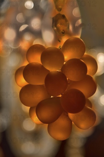 Cluster of crystal pendants on a chandelier, lit from inside