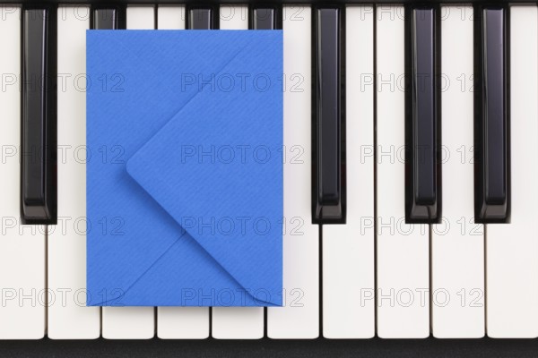 Funny arrangement envelope on the piano keybords - Flat lay image