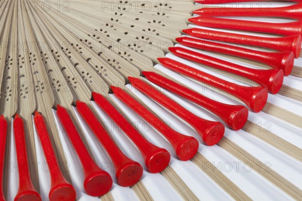 Typical Japanese hand fan made of bamboo and golf equipments
