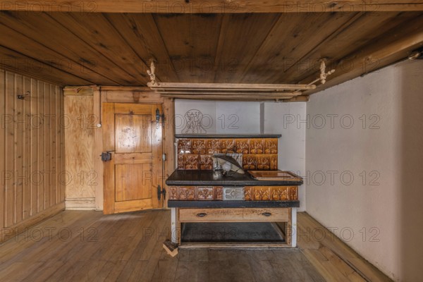 The living room with tiled stove in a house built around 1750 that has since been demolished. Menznau, Lucerne, Switzerland