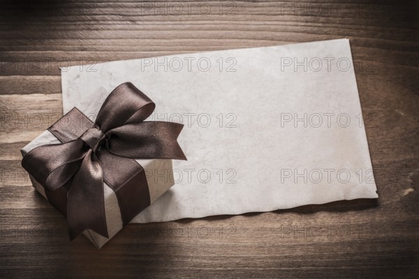 Giftbox paper on vintage wood board holiday concept