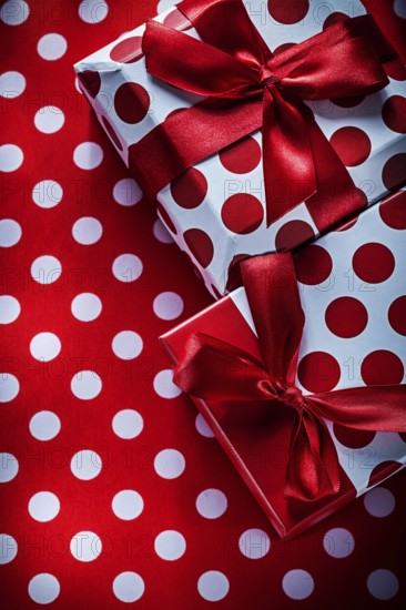 Christmas presents on polka-dot red textile holidays concept