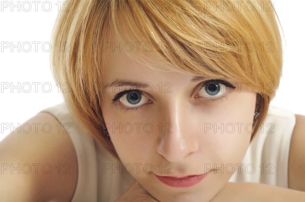 Close-up portrait of a smiling student girl with blue eyes and yellow hair