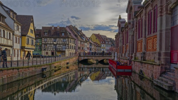 Canal running through a historic town with colorful buildings and reflections on the water, Colmar, Haut-Rhin, France