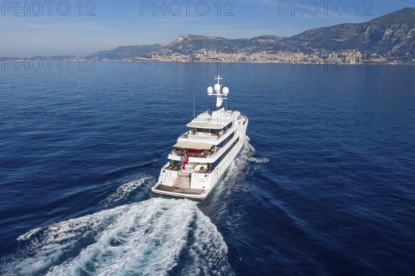 Aerial view 74 metre motor yacht AURORA, delivered in 2017 by the German shipyard Lürssen Yachts, Design Winch Design, sailing past Roquebrune Cap Martin in the morning to the Principality of Monaco, Cote d'Azur, Mediterranean Sea