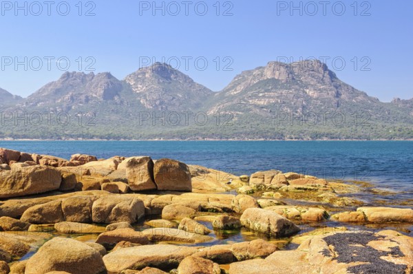 The Hazards mountain ranges in the Freycinet National Park photographed from Coles Bay, Tasmania, Australia