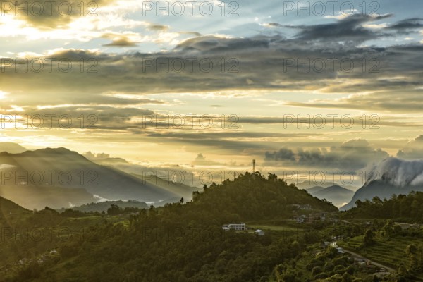 Mountains under the light of sunrise through clouds