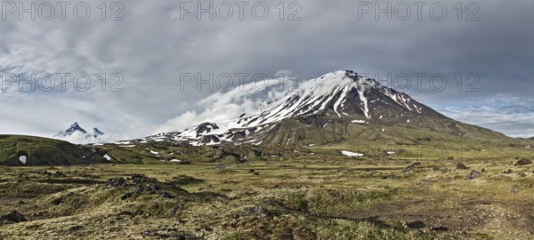 Kamchatka Peninsula beautiful mountain panorama landscape: scenery view on Oval Zimina Volcano in cloudy weather. Eurasia, Russian Far East, Kamchatka Region, Klyuchevskaya Group of Volcanoes