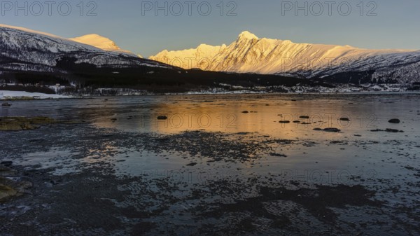 Beautiful winter landscape scene mountain in background in Northern Norway. sunset or sunrise in Mountains And Fjords