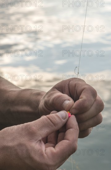 Man prepare rod for fishing. Mountain lake