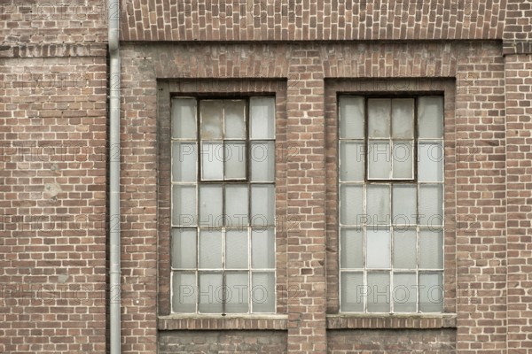 Details of an old industrial building, brick wall and windows, approx. 100 years old