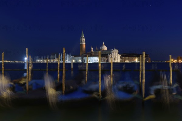 Church of San Giorgio Maggiore with gondolas at night, Venice, Italy