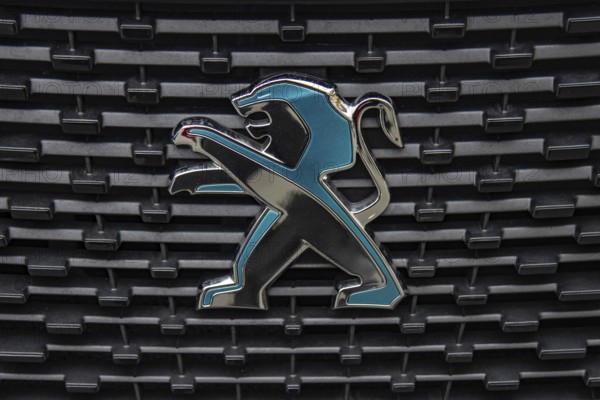 WETZLAR, Germany 2022-04-23: Peugeot logo closeup on a car grill. Peugeot as car manufacturer was founded at 1882