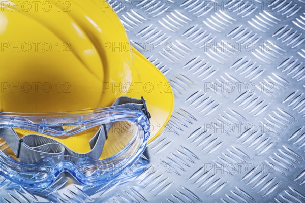 Safety spectacles building helmet on corrugated metal plate top view construction concept