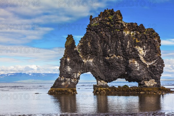 The picturesque cliff in Iceland as huge prehistoric monster. Remains of an ancient extinct volcano Hvitserkur on the sea shelf
