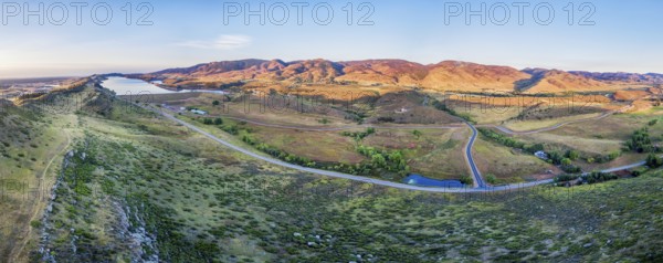 Aerial panorama of foothills near Fort Collins, Colorado with Horsetooth Reservoir, Lory State Park, Charles Hansen Canal and Centennial Road, sunrise at late summer