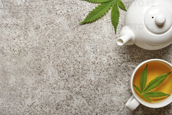 Hemp herbal tea and leaves on gray background. Calming drink concept
