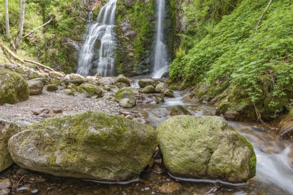 Beautiful fresh mountain waterfall in a wild and isolated valley in springtime. France