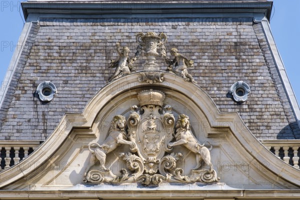 Rampant lions hold up the coat of arms of Festetics family on the tower of Festetics Palace, Keszthely, Hungary
