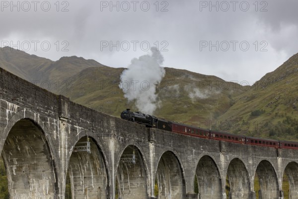 The Jacobite Steam Train, steam railway on the Glenfinnan railway viaduct, known from Harry Potter, Glenfinnan, Highlands, Scotland, Great Britain