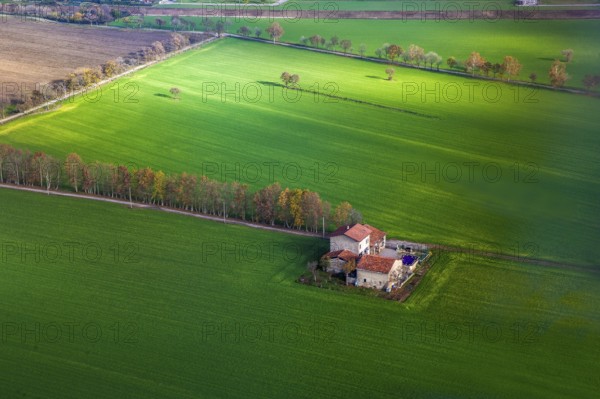 View on house and agricultural farm in Northern Italy, Several fields are green and another is black