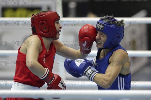 Sofia, Bulgaria - 26 February, 2021: Angelina Lukas (red) of Kazakhstan and Lacramioara Perijoc of Romania fight in their semifinal round of Fly (W51kg) category of the 72-nd International Boxing Tournament Strandja 2021, Sofia, Bulgaria