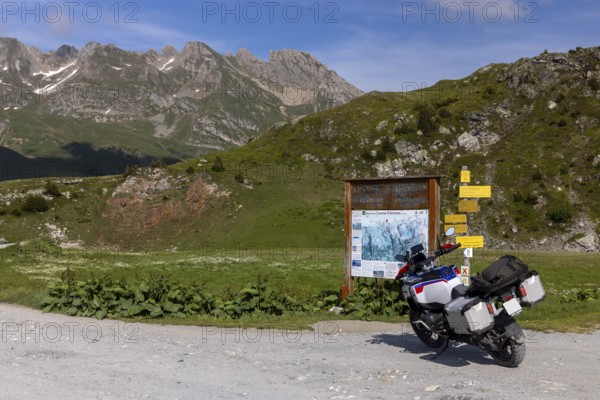 Signpost and information board, BMW R1300 GS Adventure motorbike on gravel road, Cormet d'Areches pass, Aime-la-Plagne, Savoie, France