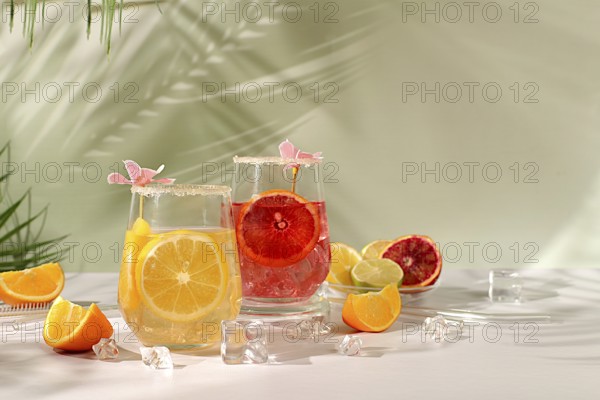 Royal cocktail of blood orange, lemon and lime, ice cubes, rum and tequila. Flyer with a glass of alcoholic drink and tropical fruits. Summer party concept. Menu for a bar or cafe