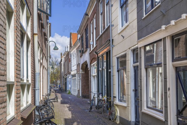 Street with historical houses in Delft downtown, Netherlands