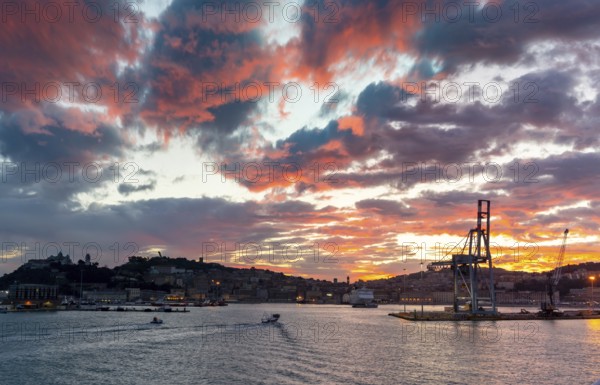 Ancona, Italy, 24 November, 2022: the harbor entrance and old town of Ancona on the Adriatic Sea at sunrise