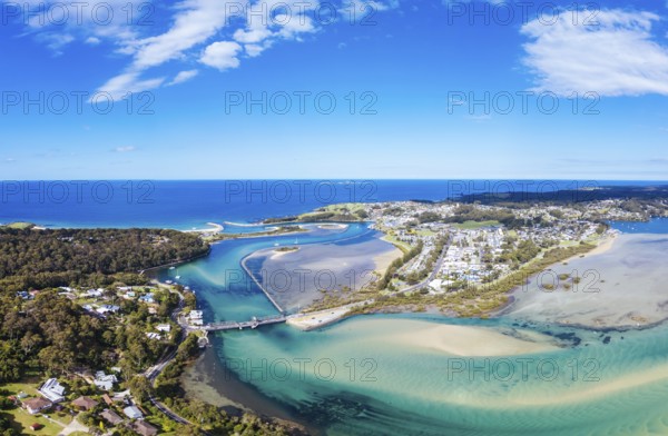 Aerial view of the idyllic coastal town of Narooma wrapped around the famous Wagonga Inlet in South Coast, New South Wales, Australia