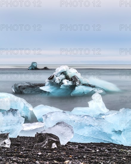 Blue icebergs and chunks floating in a calm ocean scene, iceberg Iceland, glacier, snow, ice rock, ice diamont, glacier lagoon, nature, snow, diamont beach, Iceland