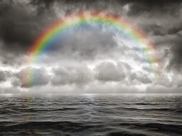A dark sky background with a colorful rainbow at the ocean