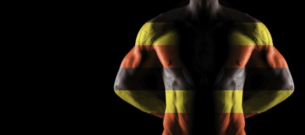 Uganda flag on muscled male torso with abs, black background