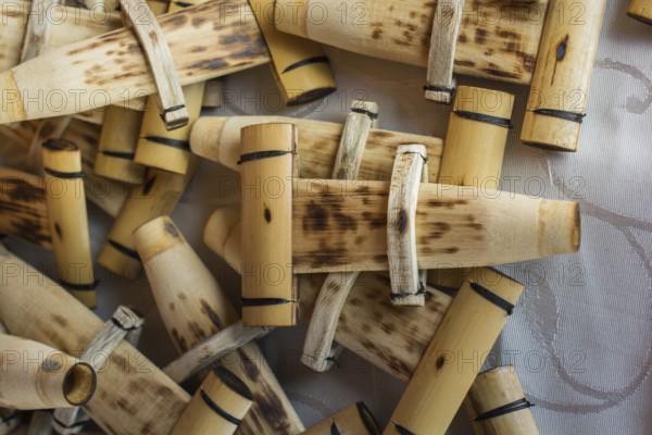 Dozens of handmade bamboo flutes in the view