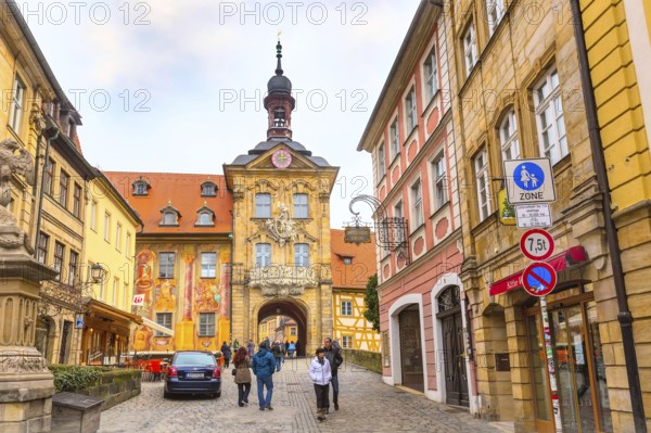 Bamberg, Germany, February 19, 2017: Icon of Bamberg Obere bridge or brucke and Altes Rathaus town hall city center, people