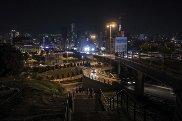 Cars drive at night on the Beirut Central Ring Road, one of the most important transport links in the capital of Lebanon. The photo shows the section of Fouad Chehab Avenue and the city skyline