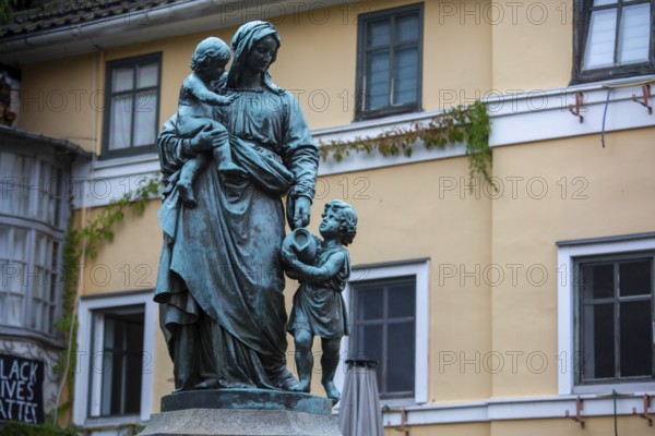 A view of the Statue of Mother Love or the Donndorf Brunnen made by the famous Adolf von Donndorf (1835-1916) portraying a mother with her two children in the act of fetching water Weimar, Germany