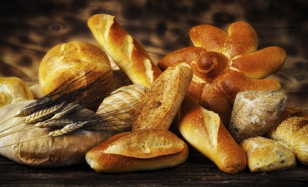 Various types of bread in a rustic setting with warm light