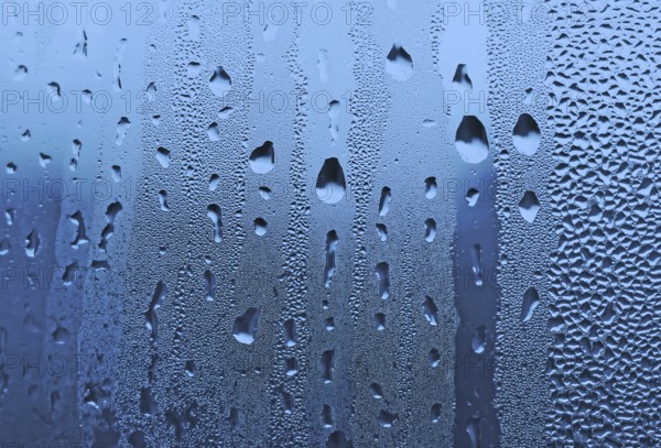 Natural large and fine water drops on glass