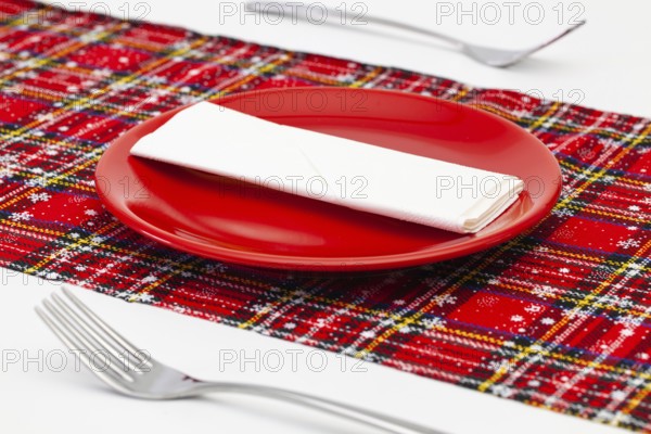 Red plate and Christmas decoration on the white wooden table.Top view. Flat Lay Image