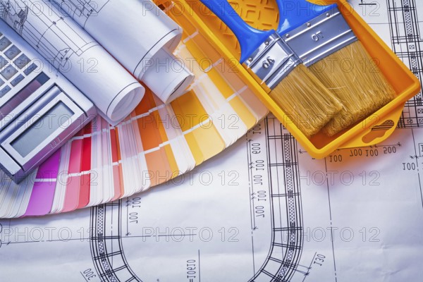 Paintbrushes paint can blueprints calculator color palette construction concept