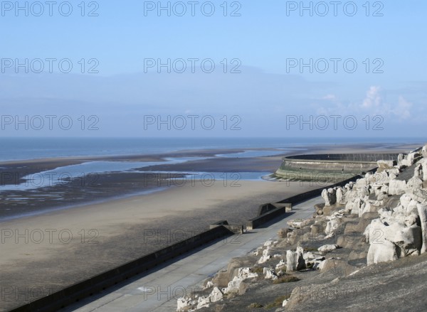 The cliffs area on the south promenade in Blackpool with the beach at low tide on a bright sunlit day