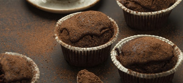 Chocolate and cocoa browny muffins with coffee cappuccino in cup angle view on brown rustic stone background, sweet homemade dark chocolate cupcakes, food photography, food photography